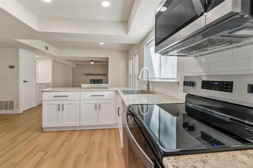 3708 Spring Meadow Lane Flower Mound, TX 75028 - Photo 17 of 39 a kitchen with stainless steel appliances granite countertop a stove and a sink