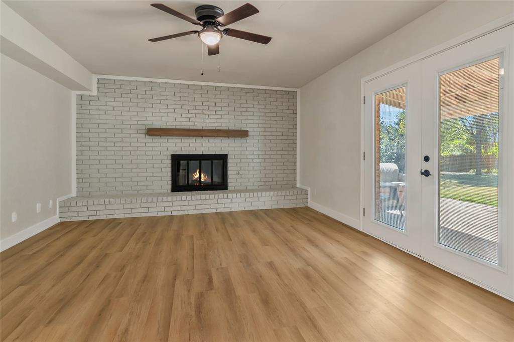 3708 Spring Meadow Lane Flower Mound, TX 75028 - Photo 20 of 39 a view of empty room with wooden floor and fireplace