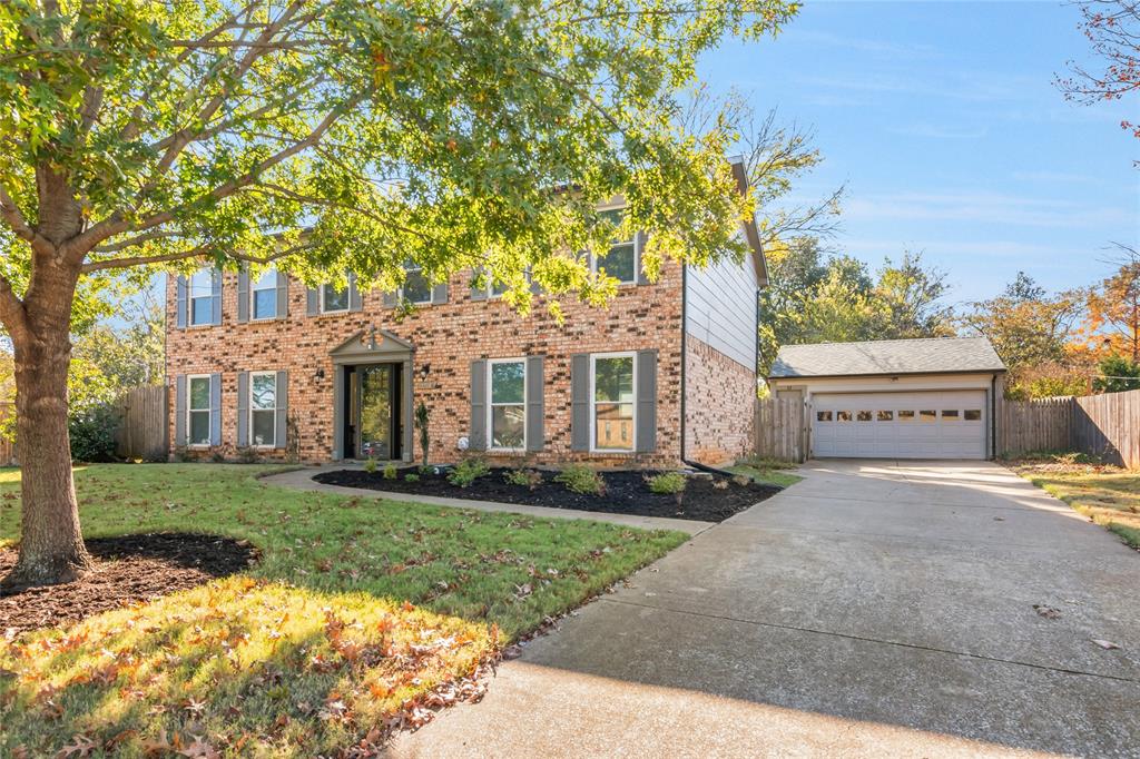 3708 Spring Meadow Lane Flower Mound, TX 75028 - Photo 2 of 39 a front view of a house with a garden and trees