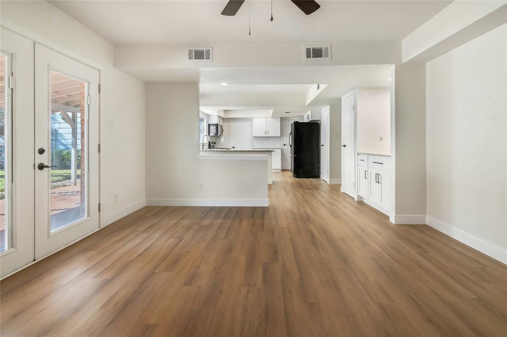 3708 Spring Meadow Lane Flower Mound, TX 75028 - Photo 21 of 39 a view of a big room with wooden floor and windows