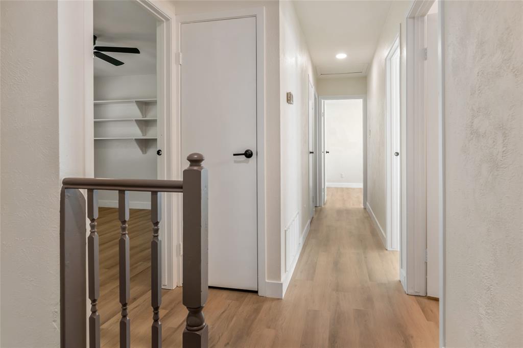 3708 Spring Meadow Lane Flower Mound, TX 75028 - Photo 23 of 39 a view of a hallway with wooden floor