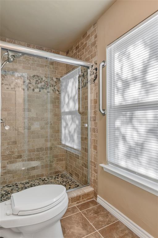 3708 Spring Meadow Lane Flower Mound, TX 75028 - Photo 26 of 39 a bathroom with a shower and a toilet