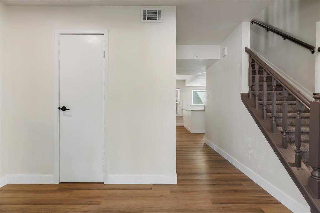 3708 Spring Meadow Lane Flower Mound, TX 75028 - Photo 3 of 39 a view of a hallway with wooden floor and staircase