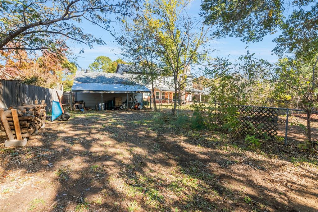 3708 Spring Meadow Lane Flower Mound, TX 75028 - Photo 37 of 39 a front view of a house with a garden
