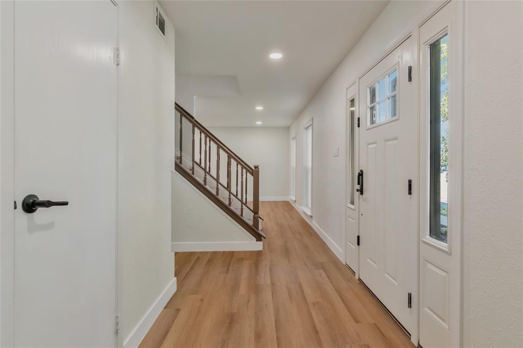 3708 Spring Meadow Lane Flower Mound, TX 75028 - Photo 4 of 39 a view of a hallway with wooden floor and staircase