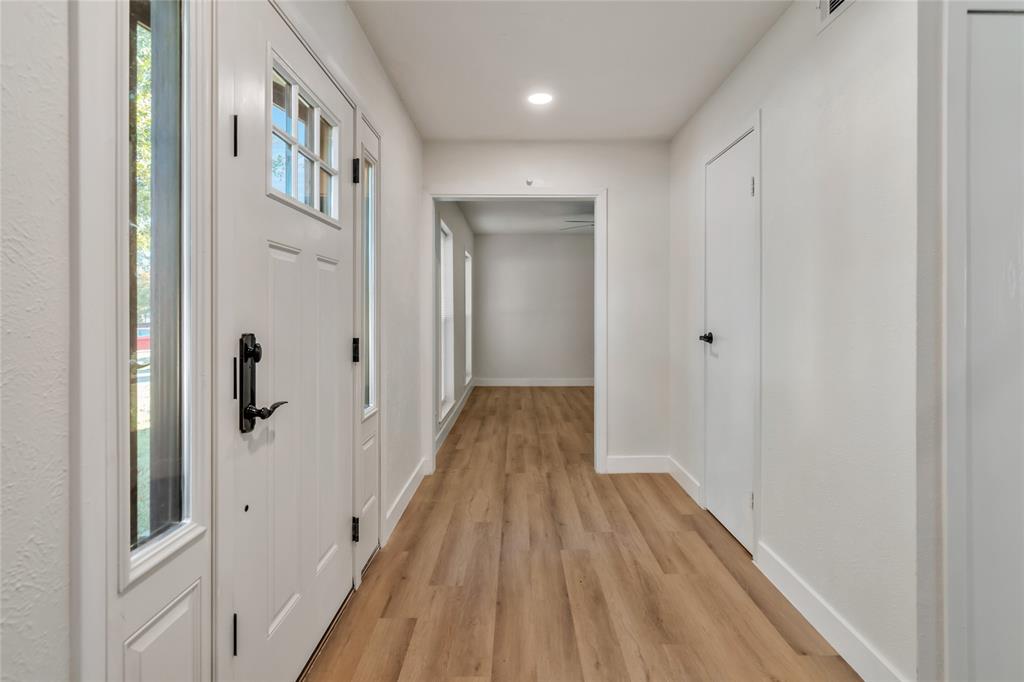 3708 Spring Meadow Lane Flower Mound, TX 75028 - Photo 5 of 39 a view of a hallway with wooden floor and staircase
