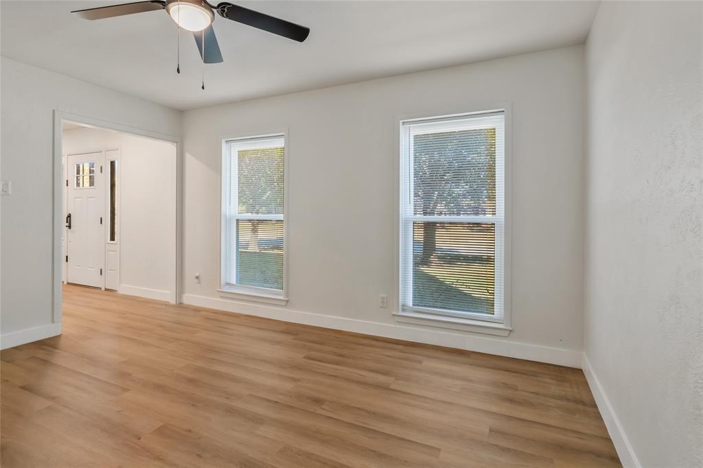 3708 Spring Meadow Lane Flower Mound, TX 75028 - Photo 7 of 39 an empty room with wooden floor chandelier and windows