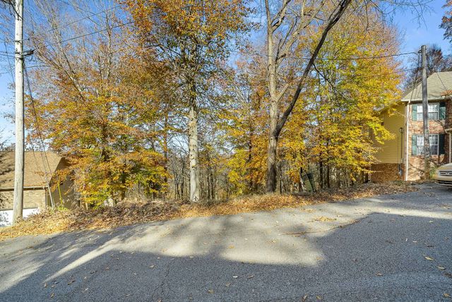 a view of yard with wooden fence