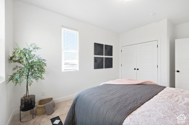 153 East Rochefort Court Sandy, UT 84070 - Photo 23 of 43 2nd bedroom. Recessed ceiling light fixture, window with blinds, paneled closet doors with black hardware, and carpet flooring