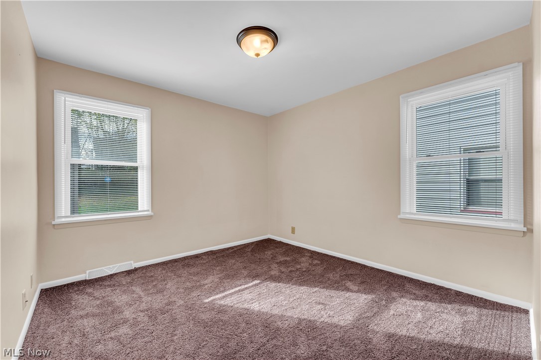 9716 Alexander Road Cleveland, OH 44125 - Photo 12 of 30 Empty room with carpet flooring and baseboards