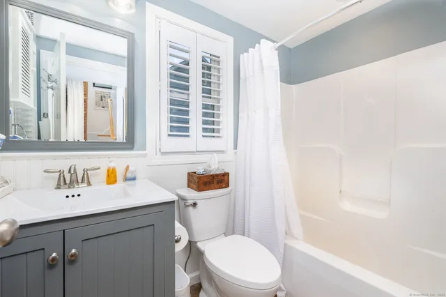 a bedroom with a bed and a tv on table