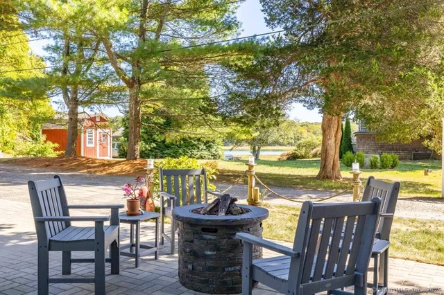 a view of a patio with furniture and a backyard