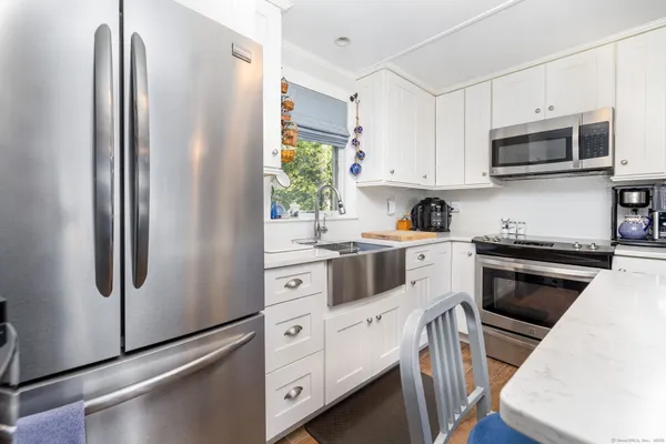 a kitchen with a table chairs sink and cabinets