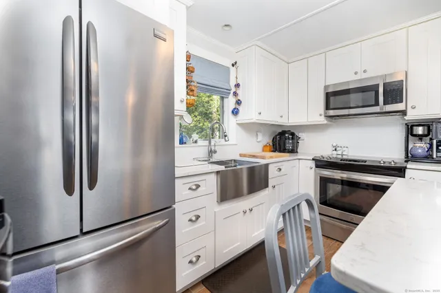 a kitchen with a table chairs sink and cabinets
