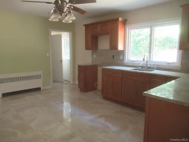 a kitchen with a sink chandelier and window
