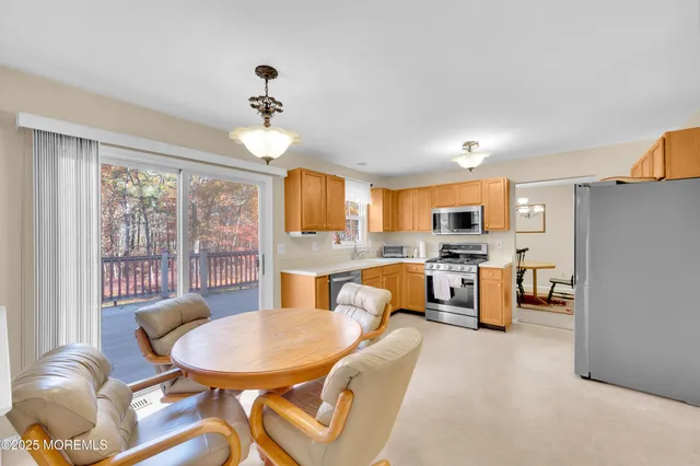 a living room with furniture a dining table and a chandelier