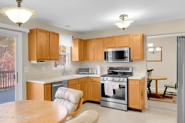a kitchen with a stove a sink and a refrigerator