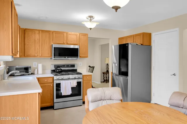 a kitchen with stainless steel appliances a stove a refrigerator and a stove