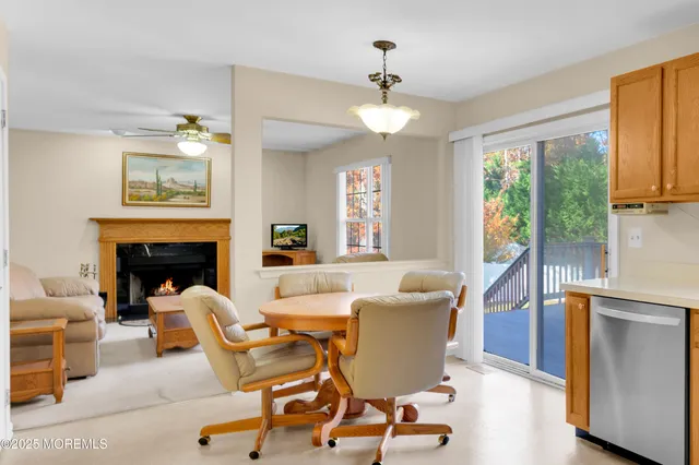 a living room with furniture a fireplace and a large window