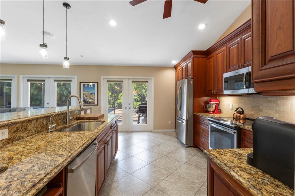 6060 Painted Leaf Lane Naples, FL 34116 - Photo 13 of 49 a kitchen with granite countertop lots of counter top space