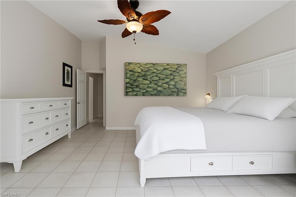 6060 Painted Leaf Lane Naples, FL 34116 - Photo 17 of 49 a bedroom with a bed dresser and a window