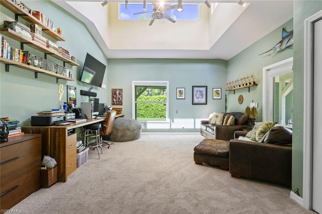 6060 Painted Leaf Lane Naples, FL 34116 - Photo 24 of 49 a living room with furniture gym equipment and a window
