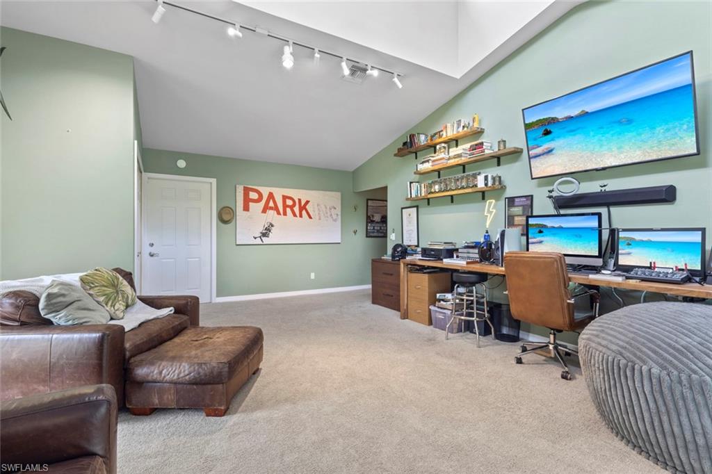 6060 Painted Leaf Lane Naples, FL 34116 - Photo 27 of 49 a living room with furniture and a flat screen tv