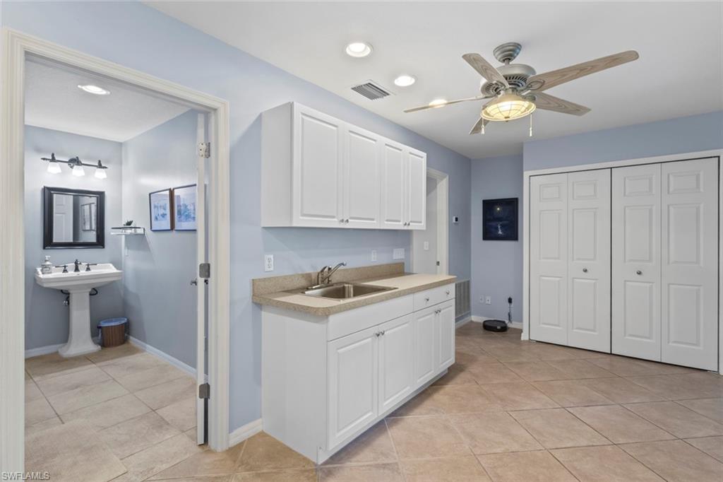 6060 Painted Leaf Lane Naples, FL 34116 - Photo 34 of 49 a view of a kitchen with a sink cabinets and stainless steel appliances