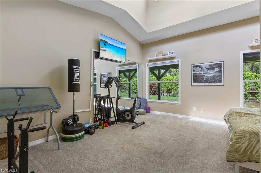 6060 Painted Leaf Lane Naples, FL 34116 - Photo 38 of 49 a room with gym equipment and a flat screen tv