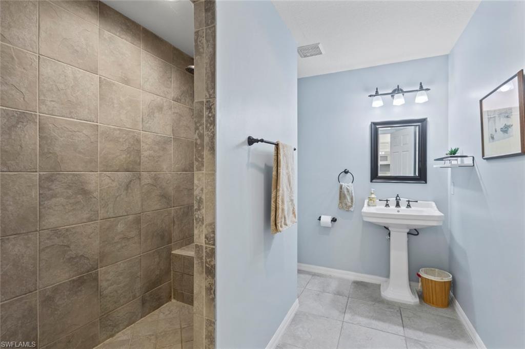 6060 Painted Leaf Lane Naples, FL 34116 - Photo 39 of 49 a bathroom with a sink a toilet and mirror