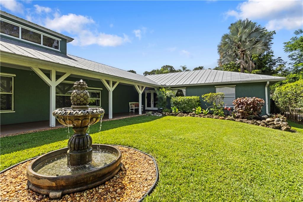 6060 Painted Leaf Lane Naples, FL 34116 - Photo 4 of 49 a front view of a house with garden