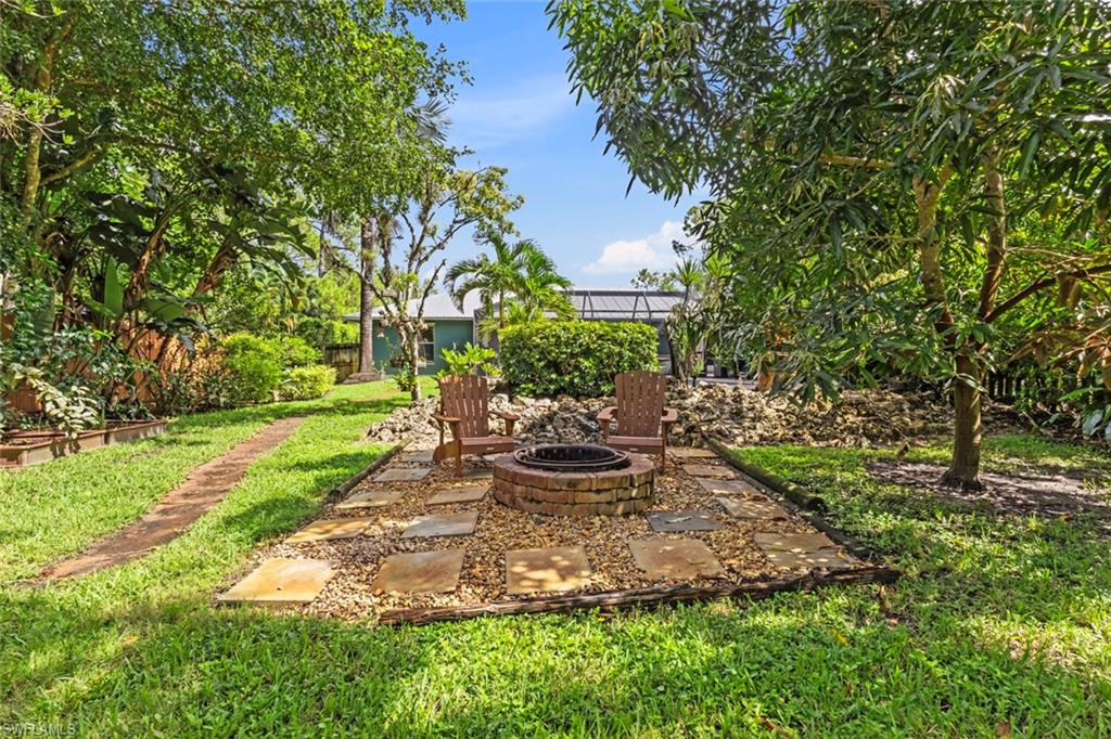 6060 Painted Leaf Lane Naples, FL 34116 - Photo 43 of 49 a view of a backyard with chair and garden