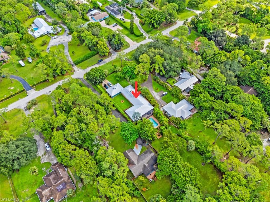6060 Painted Leaf Lane Naples, FL 34116 - Photo 45 of 49 a backyard of a house with lots of green space
