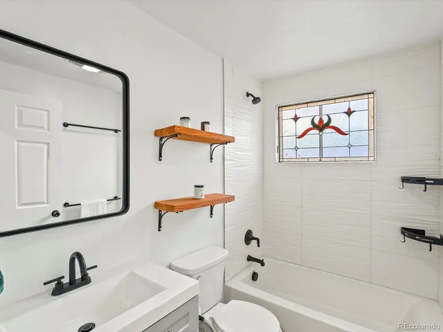 a kitchen with stainless steel appliances granite countertop a sink a stove and a wooden floors