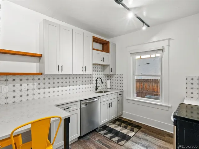 a kitchen with stainless steel appliances a stove a sink and a microwave