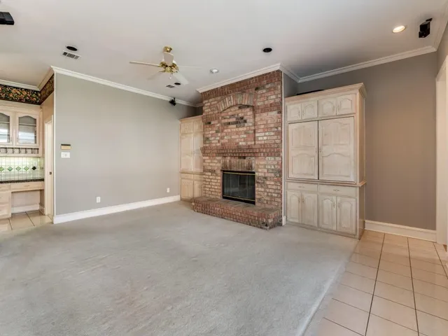 a view of a livingroom with an empty space and a fireplace