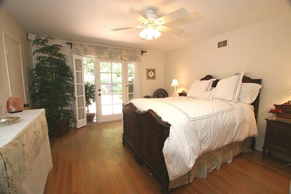 213 Alston Road Santa Barbara, CA 93108 - Photo 7 of 13 a bedroom with a bed and a chandelier