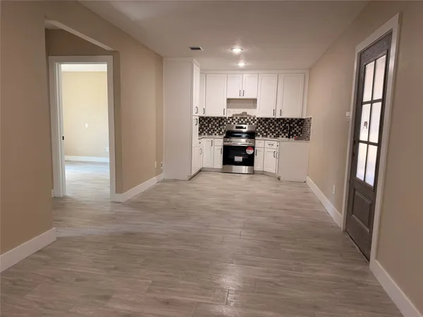 a kitchen with white cabinets and white appliances