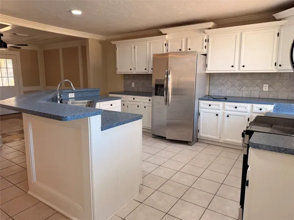a kitchen with stainless steel appliances granite countertop a refrigerator sink and stove