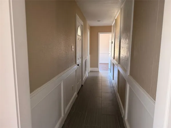 a view of a hallway with a wooden floor