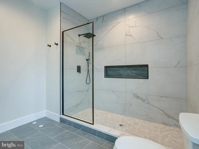 a bathroom with a shower a toilet and a sink