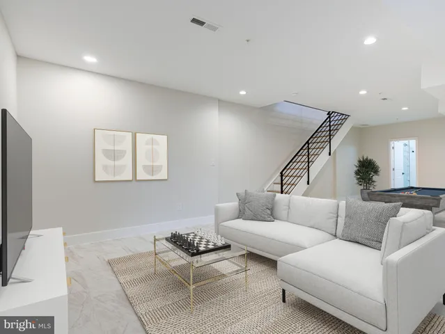 a living room with furniture and a ceiling fan
