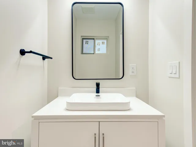 a bathroom with a sink and mirror