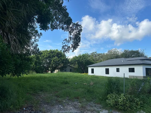 a front view of house with a garden