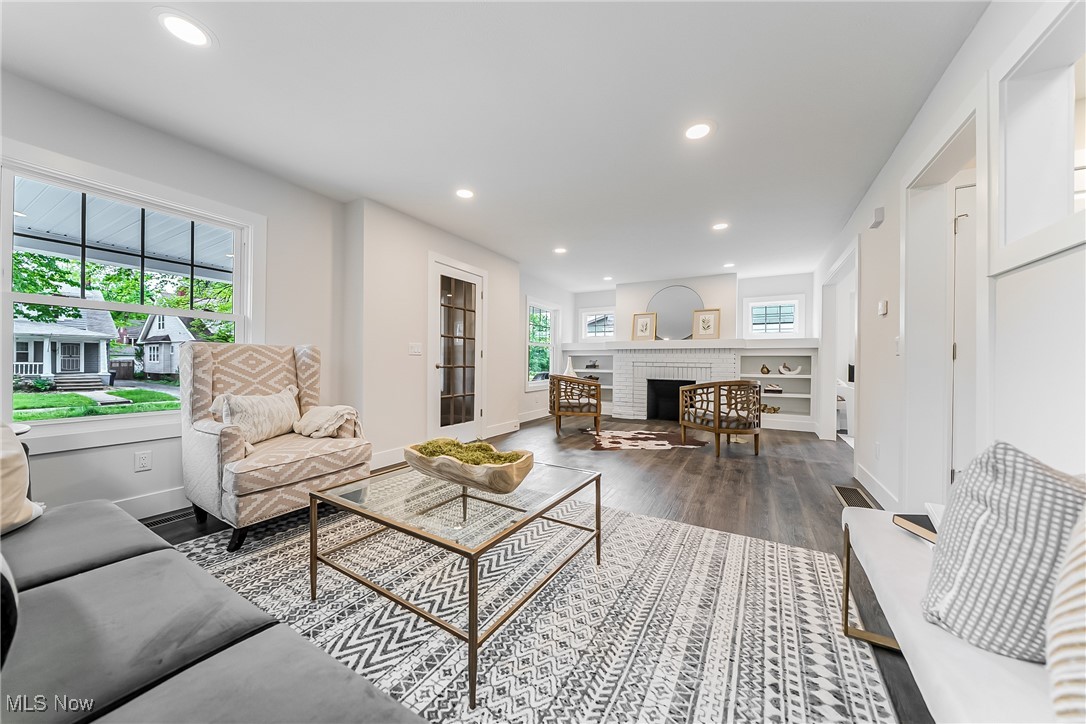 3817 Summit Park Road Cleveland Heights, OH 44121 - Photo 5 of 29 Living area featuring wood-look floors, recessed lighting, and a fireplace with built in shelving