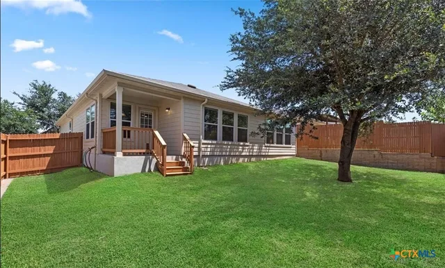 a view of a house with backyard porch and sitting area