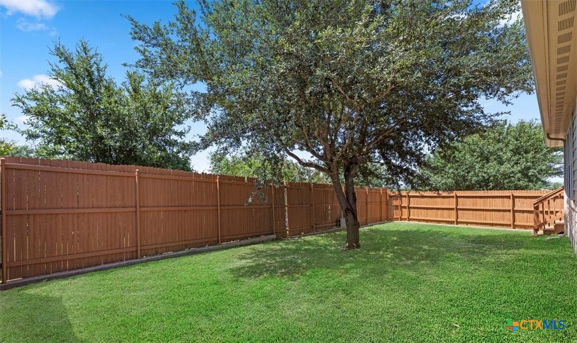 6046 Mule Deer Schertz, TX 78108 - Photo 18 of 19 a view of backyard with wooden fence