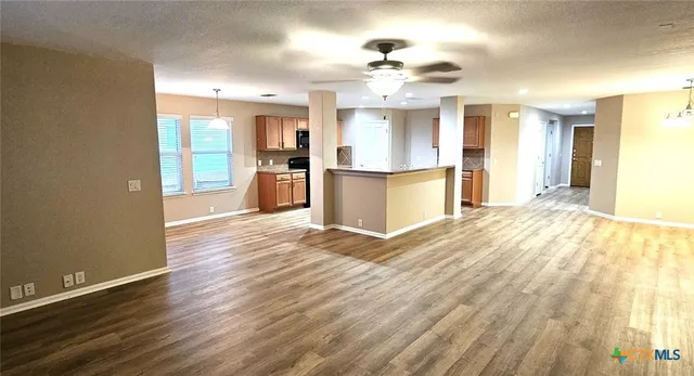 a view of a kitchen with a sink and wooden floor