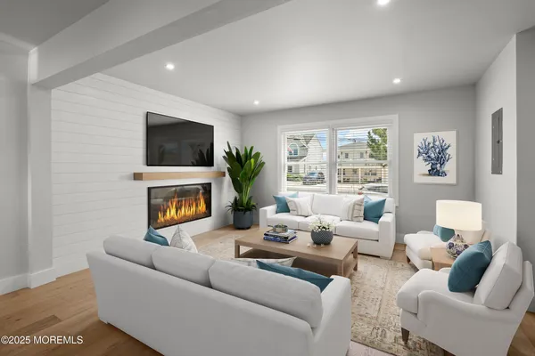 a living room with furniture a flat screen tv and a fireplace