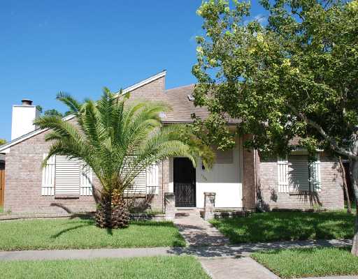 7306 Diamond Ridge Drive Corpus Christi, TX 78413 - Photo 4 of 4 a front view of a house with a garden